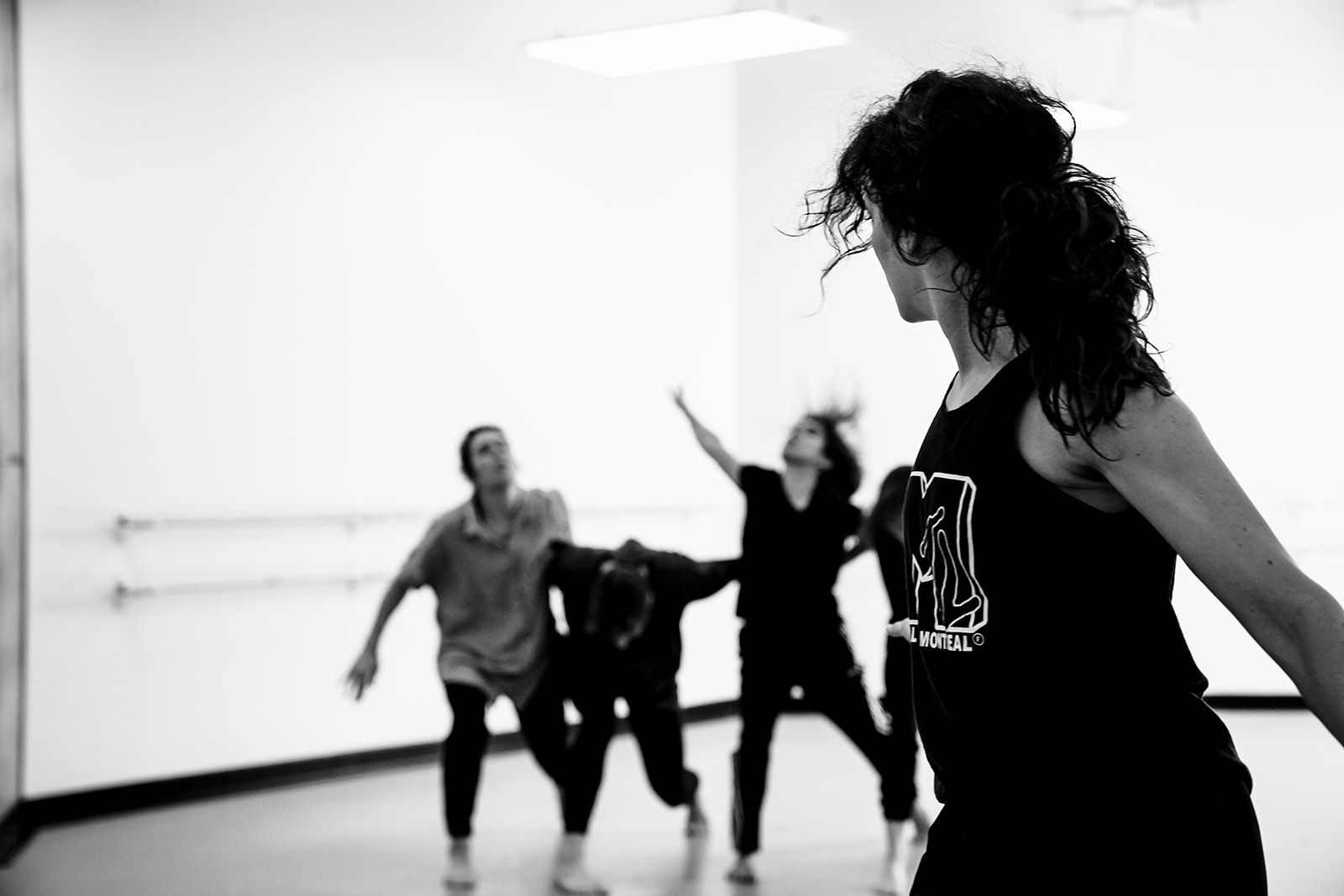 A woman leads a group in a dance routine