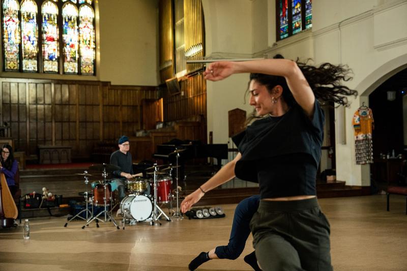 A dancer spins in a church.