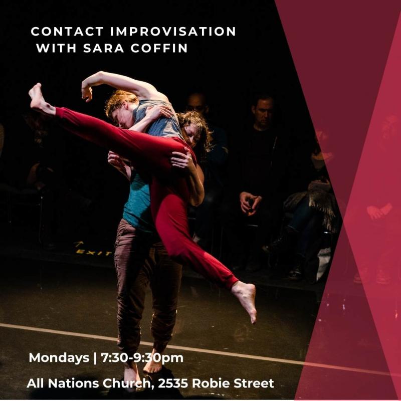 Two female dancers on a dark stage, one dancer in a blue shirt lifts the second dancer wearing red pants