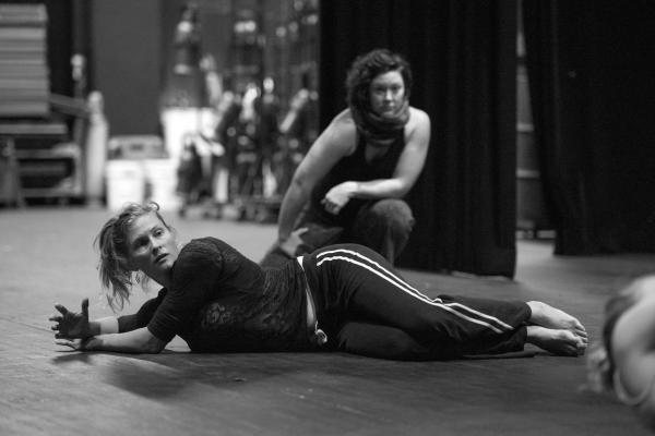 two dancers crouching on stage