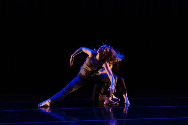 Dancer in blue light leaning back with passion