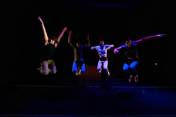 An image of four people caught mid jump