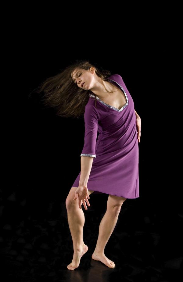 A dancer reaches arm and foot out to the side. 