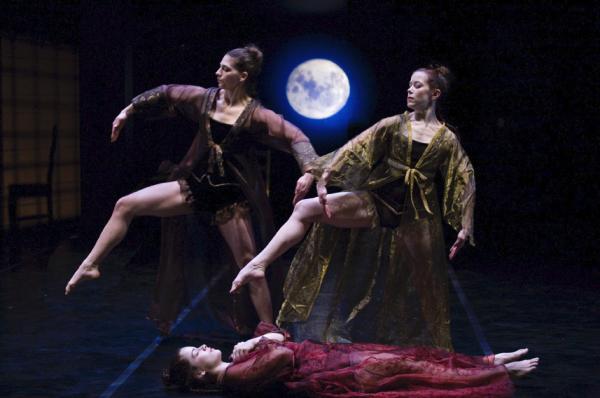 Three dancers move in front of backdrop of a night sky and moon.