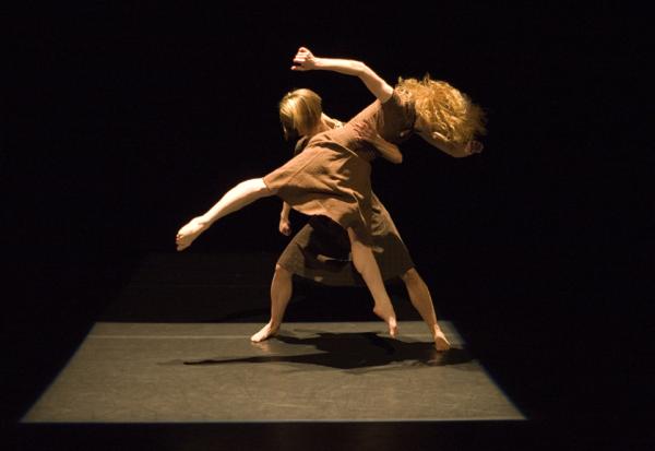 A dancer lifts another dancer. 