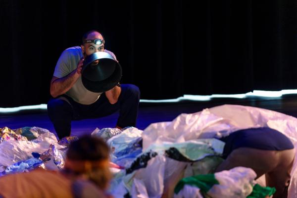 Man holds plastic debris like a megaphone