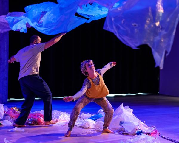 Two people dancing underneath a plastic tarp