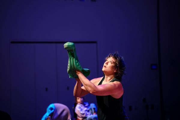 Woman dancing with a plastic green turtle