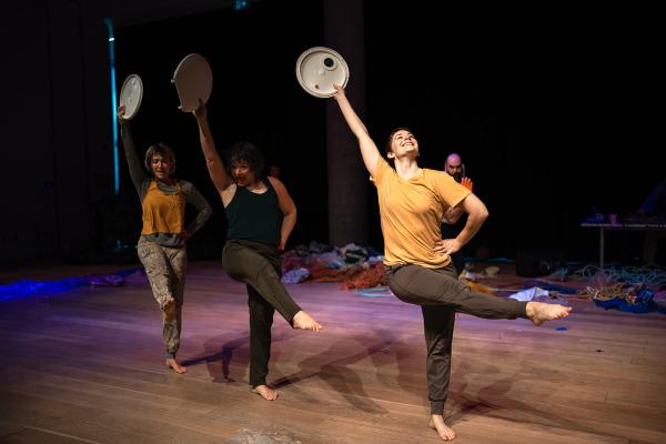 Three people dancing with paper plates