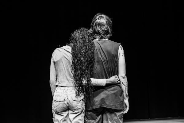 Two dancer facing the back. One embraces the other