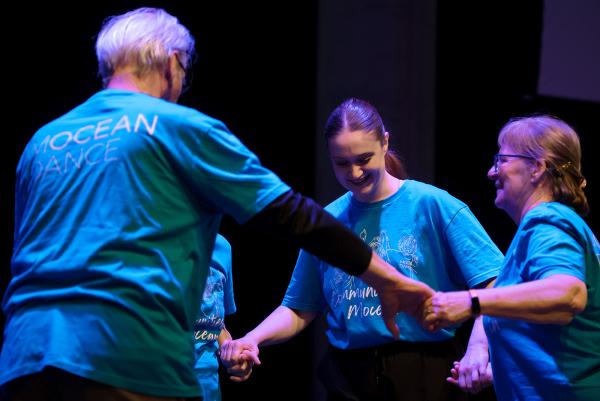 dancers in a circle holding hands