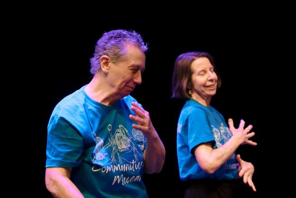 two seniors in blue shirts smilling