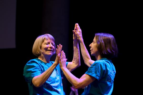 two people with their palms pressed together