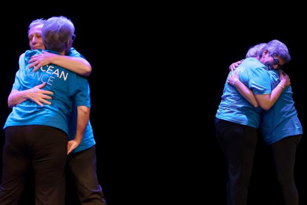 two pairs of people hugging