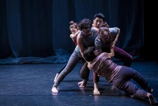 Five dancers in a group configuration