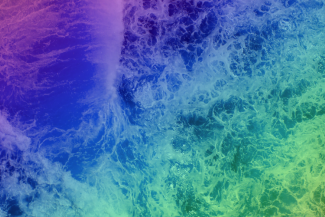 An overhead shot of ocean waves with a multicoloured filter.