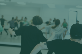 A green tinted photo of dancers in a studio.