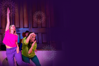 Two people dance on a dark purple backdrop with firework graphics