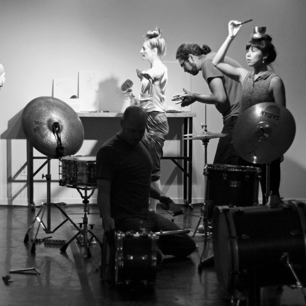 dancers balancing objects on their head in re-writing distance