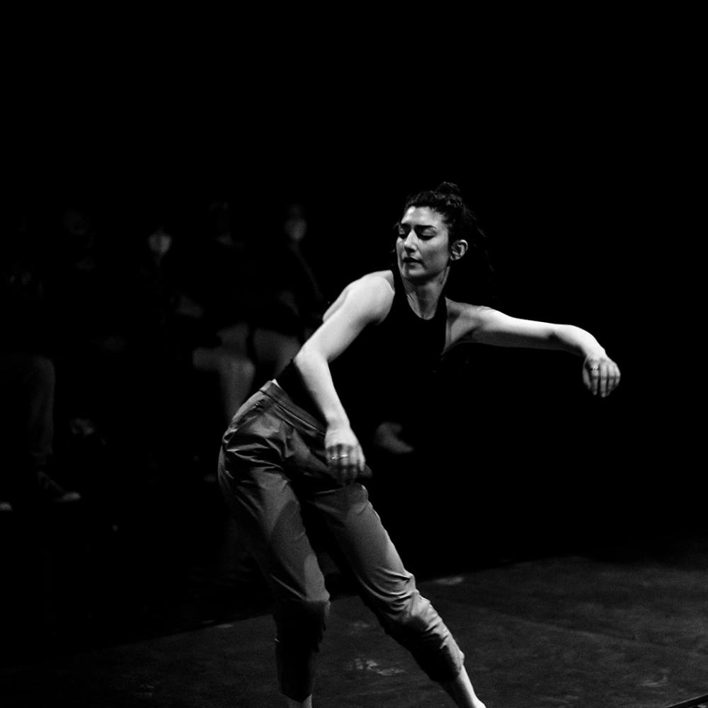 A woman dances leaning one hip out to the side